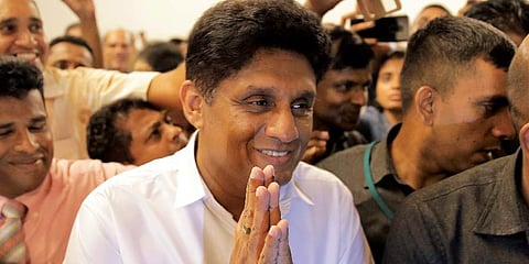 Presidential candidate representing Sri Lanka's governing party Sajith Premadasa greets the gathering as he leaves after a meeting with a group of civil society members in Colombo, Sri Lanka. (Photo | AP)