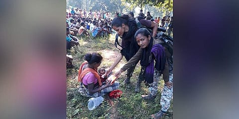 Women police personnel offering biscuits and snack to tribal woman in Dantewada (Photo | Express)