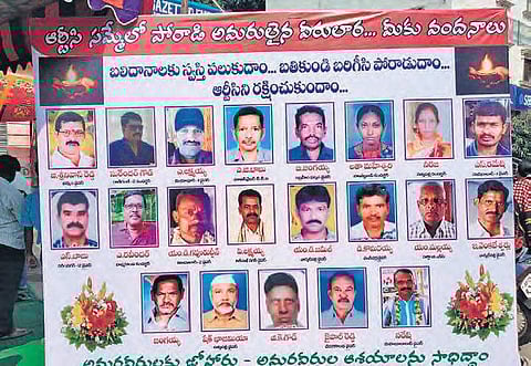 TSRTC JAC displays a board on Thursday in front of Nizamabad district collector’s office with pictures of RTC employees who have died since the RTC strike began