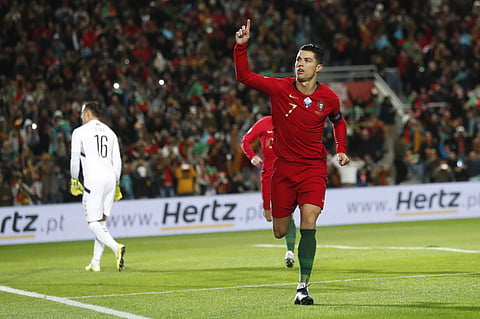 Portugal's Cristiano Ronaldo celebrates after scoring the opening goal during the Euro 2020 group B qualifying soccer match between Portugal and Lithuania at the Algarve stadium outside Faro, Portugal, Thursday, Nov. 14, 2019. | (Photo | AP)