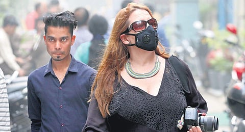 Commuters take protection from  the smog and toxic air in New Delhi. (Photo | Shekhar Yadav, EPS)