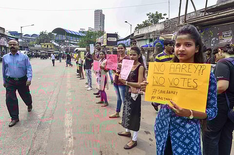 Mumbai Activists and locals hold placards to protest against cutting of trees in Aarey Colony. ( Photo | PTI )