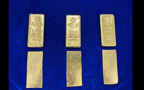 Three gold bars weighing 1 kg each with foreign markings along with 3 gold plates without any markings, of 24k purity. (Photo | Commissioner of  Customs  Chennai International Airport)