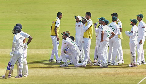 Bangladeshi cricketers wait for the third umpire decision against Indian batsman Mayank Agarwal on the second day the first cricket test match against India in Indore. (Photo | PTI)