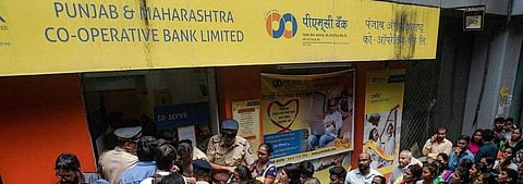 Account holders line up in front of a branch of PMC Bank (Photo| Bloomberg)