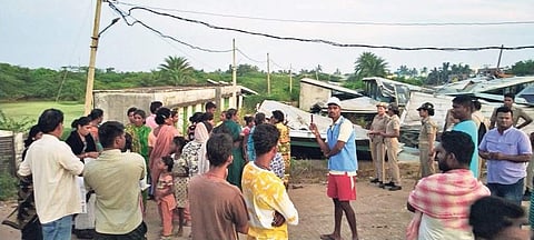 People outside the dry fish unit that was demolished in Gopalpur