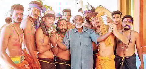 Siddique, staff of Vavar Mosque at Erumeli, with devotees on the premises  of the mosque on Saturday | A Sanesh