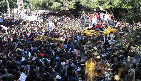 JNU students try to get past police barricades during a protest march towards Parliament on the first day of the Winter Session demanding a total rollback of the hostel fee hike. (Photo | PTI)