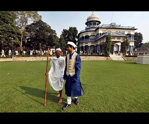 School children dressed as Mahatma Gandhi and Jawahar Lal Nehru walk at Nehru's ancestral home, Anand Bhawan in Prayagraj. (Photo | AP)