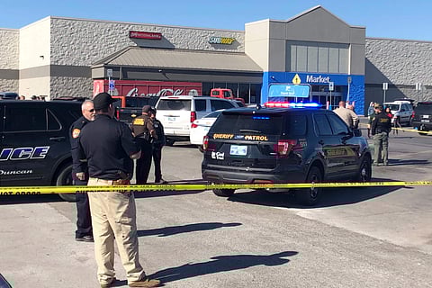 Law enforcement work the scene where two men and a woman were fatally shot Monday, Nov. 18, 2019, outside a Walmart store in Duncan, Okla. (Photo | AP)
