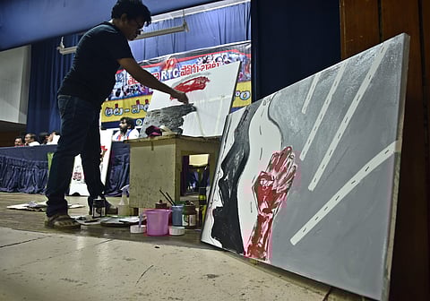 Artist Akbar paints in support of the RTC strike at Subdaraiah Vignanam Kendram on Monday| Vinay Madapu