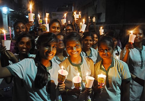 Students take part in a candlelight rally against child abuse organised by Child Line in Vijayawada on Tuesday| P Ravindra Babu