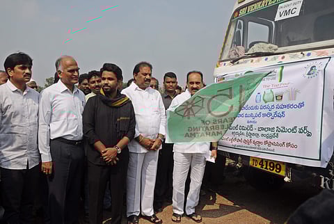 Minister Balineni Srinivasa Reddy flags off two trucks carrying plastic waste to cement factory, along with VMC Commissioner V Prasanna Venkatesh at Ajit Singh Nagar in Vijayawada on Tuesday| Prasant Madugula