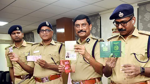 Visakhapatnam Police Commissioner RK Meena showing to the media seized sim cards and passports in a recent case during a press meet held in Visakhapatnam on Wednesday (Express by G Satyanarayana)