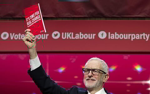 Jeremy Corbyn, Leader of Britain's opposition Labour Party, holds a copy of the manifesto on stage at the launch of Labour's General Election manifesto, at Birmingham City University, England. (Photo | AP)