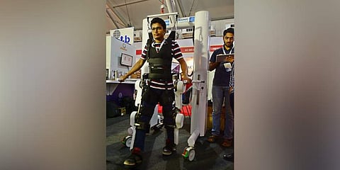 A visitor wear a Robotic Exosketelon Assisted Rehabilitation System (REARS) robot gear. (Photo | Shriram B N, EPS)