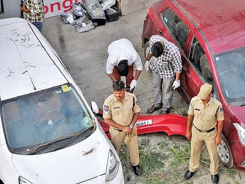 Hyderabad Clues team collecting parts of the car which fell off the Biodiversity flyover in Hyderabad on Saturday. (Photo | Senbagapandiyan, EPS)