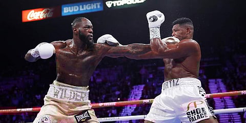 Deontay Wilder hits Luis Ortiz during their WBC heavyweight title boxing match. (Photo | AP)