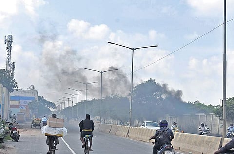 Plumes of smoke rising from burning garbage at corporation dump yard at Kodungaiyur | Express