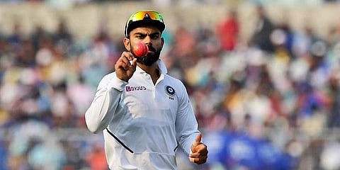 India's captain Virat Kohli tosses a pink ball during the first day of the second test match between India and Bangladesh, in Kolkata. (Photo | AP)