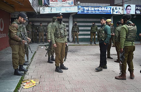 Senior police officials examine the spot of grenade blast hurled by militants in Srinagar. (Photo| PTI)