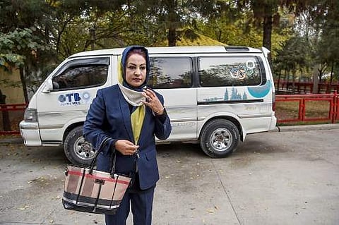 Parisa Haidary walks away from a mini-bus after she dropped off her women passengers in Kabul. A first-of-its kind service called Pink Shuttle is helping women navigate the many challenges they face getting around Kabul, where a woeful lack of transport o