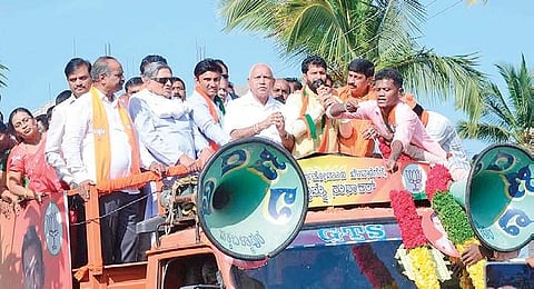 CM B S Yediyurappa, former CM S M Krishna and BJP bypoll candidate Dr Sudhakar during election campaign at Manchenahalli near Chikkaballapura on Tuesday.