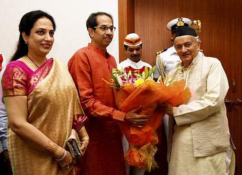 Maharashtra Chief Minister designate Uddhav Thackeray along with wife Rashmi Thackeray presents a bouquet to Governor Bhagat Singh Koshyari at Raj Bhavan in Mumbai. (Photo | PTI)