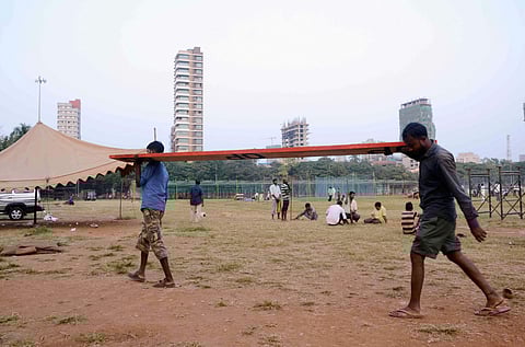 Workers carry a wooden plank as preparations are in full swing for the swearing-in ceremony of Shiv Sena chief Uddhav Thackeray as Maharashtra chief minister at Shivaji Park in Mumbai Wednesday Nov. 27 2019. (Photo | PTI)