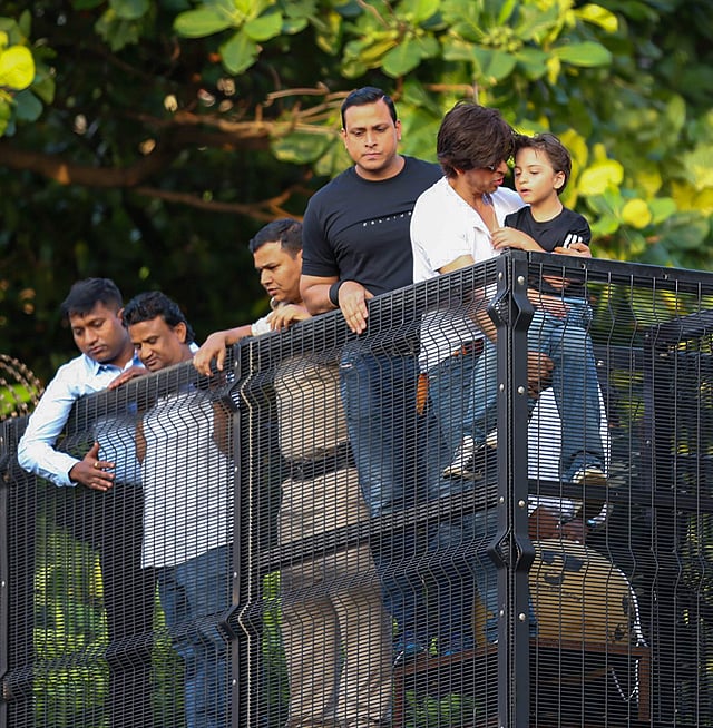 Shah Rukh Khan was escorted by heavy security even as he remained within the boundaries of Mannat. Also seen is his toddler son AbRam.  (Photo | PTI)