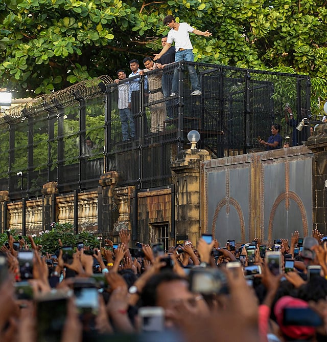 SRK performed his signature romantic hero move much to the delight of his fans who had come from far-off places to greet the star on his birthday.  (Photo | PTI)