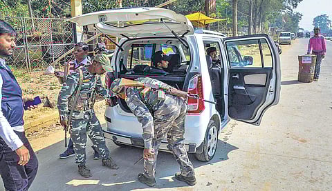 Security forces check a four-wheeler ahead of the first phase of Jharkhand Assembly Election, at NH 75. (Photo | PTI)