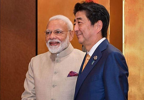Prime Minister Narendra Modi shakes hands with his Japanese counterpart Shinzo Abe prior to their meeting in Osaka, Japan (Photo| PIB)