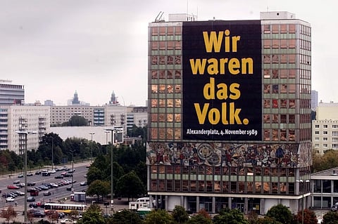 In this Oct. 7, 1999, file photo a huge poster hangs on a house on the occasion of the 50th anniversary of the former GDR in the Karl-Marx-Allee avenue in eastern part of Berlin. (Photo| AP)