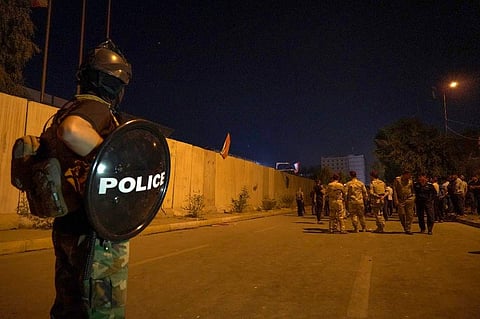 Iraqi security forces gather behind a wall protecting the Iranian consulate in the Shiite Muslim shrine city of Karbala. (Photo| AFP)
