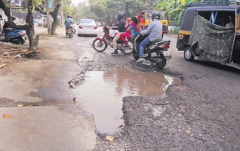 Two-wheeler riders trying to negotiate a waterlogged crater on the P V Antony Road on Sunday | A Sanesh