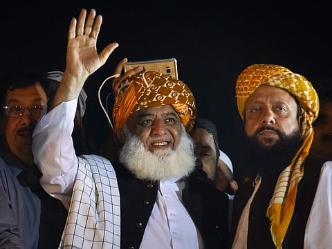 Firebrand cleric Maulana Fazlur Rehman, center, and head of the Jamiat Ulema-e-Islam party waves to his supporters during an anti-government march, in Islamabad, Pakistan, Sunday, Nov. 3, 2019. | (Photo | AP)