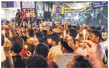 Police personnel hold a candle light protest at the Delhi Police HQ. (Photo | special arrangement)