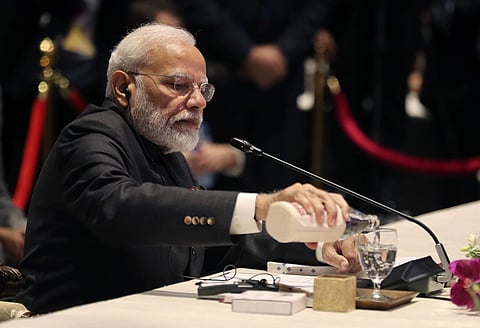 India's Prime Minister Narendra Modi pours water into a glass as he waits for transmission glitch to his voice receiver to be fixed during The Association of Southeast Asian Nations ASEAN-India summit in Nonthaburi, Thailand, Sunday, Nov. 3, 2019.  | (Pho