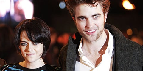 In the photo from 2009, Kristen Stewart and Robert Pattinson pose for the photographers prior to the UK fan party of their film 'New Moon' from the Twilight series in London. (Photo | AP)