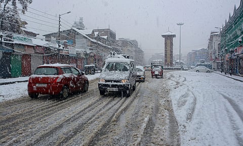 Vehicles move slowly on a snow covered road during season's first heavy snowfall in Srinagar Thursday Nov. 7 2019. | (Photo | PTI)