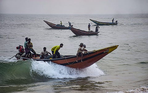 Fishermen take their boats to a safe harbour from the sea following Cyclone Bulbul warning in Puri (Photo| PTI)