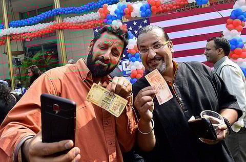 Indians take a selfie with currency notes after PM Modi announced demonetisation of higher currency. | PTI