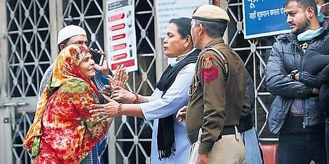 A woman pleads to a security woman to allow her enter the emergency ward of LNJP  hospital in New Delhi on Sunday. (Photo | Arun Kumar, EPS)