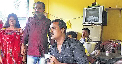 Alim Shaikh showing his Awaaz insurance card