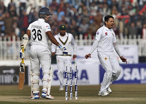 Pakistani pacer Mohammad Abbas, right, celebrates after taking the wicket of Sri Lankan batsman Dinesh Chandimal, left. (Photo | AP)
