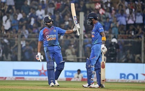 India's Rohit Sharma, left, raises his bat after scoring 50 runs as Lokesh Rahul looks on. (Photo | AP)
