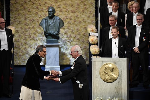 Abhijit Banerjee of India receives the Sveriges Riksbank Prize in Economic Sciences in Memory of Alfred Nobel from King Carl Gustaf of Sweden. (Photo | AP)