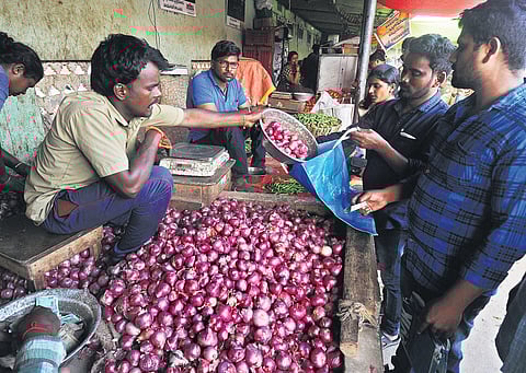 A vendor selling onions at Swaraj Maidan Rythu Bazaar in Vijayawada on Thursday. (Photo | Prasant Madugula/EPS)