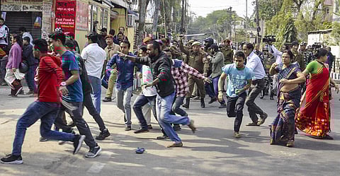 Security personnel disperse protestors during curfew at VIP Road in Guwahati Thursday. (Photo | PTI)